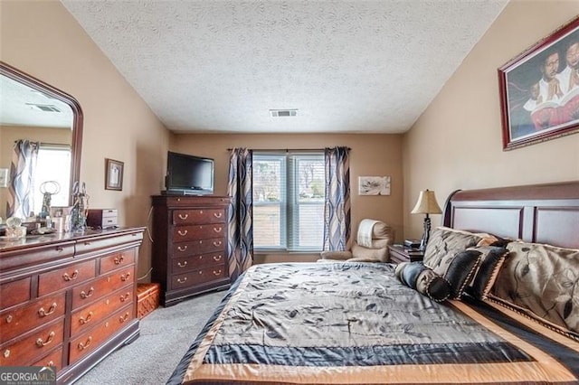 carpeted bedroom with multiple windows, a textured ceiling, and vaulted ceiling