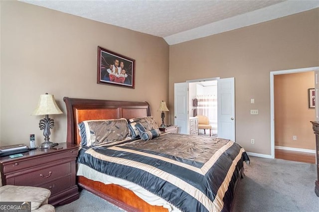 carpeted bedroom with lofted ceiling and a textured ceiling