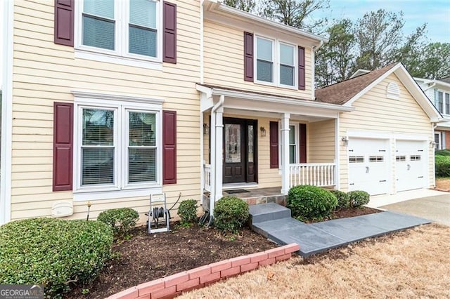 view of front of home featuring covered porch and a garage