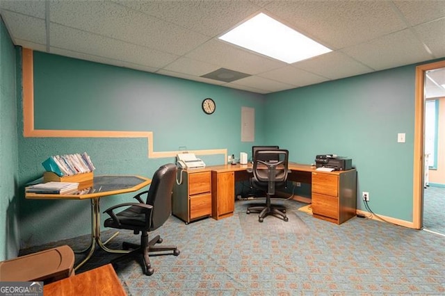 carpeted home office with a paneled ceiling