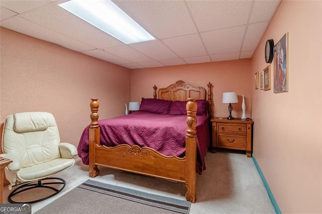 carpeted bedroom featuring a paneled ceiling