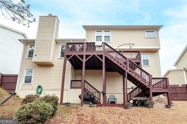 rear view of property featuring a wooden deck