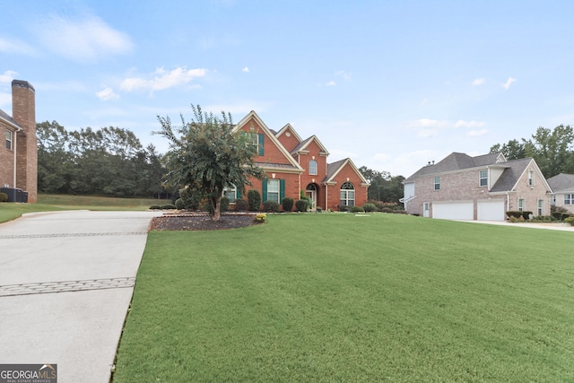 view of front of house featuring a garage and a front lawn