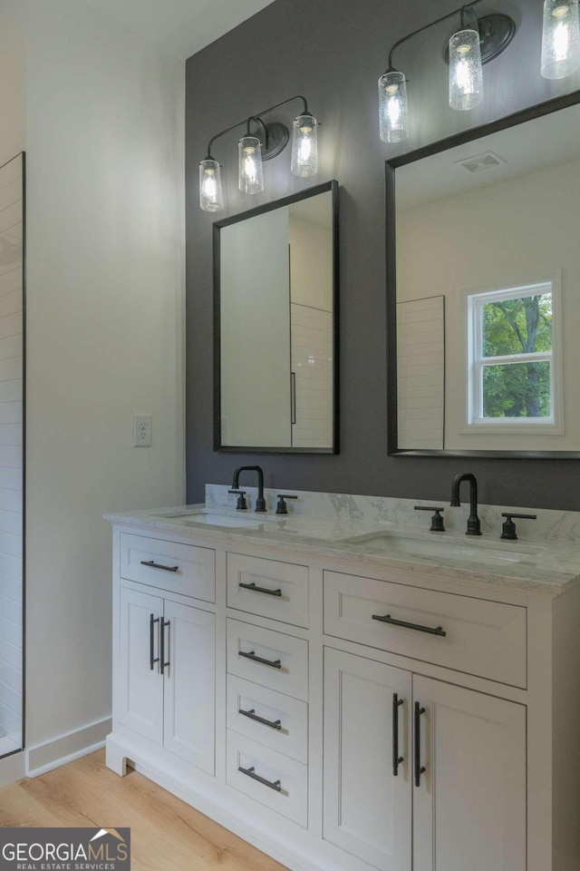 bathroom with vanity and hardwood / wood-style floors