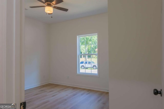 empty room featuring light wood-type flooring and ceiling fan