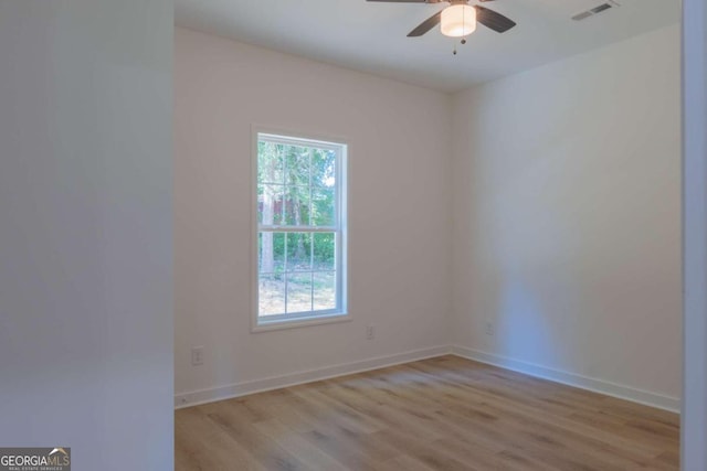 empty room with light wood-type flooring and ceiling fan