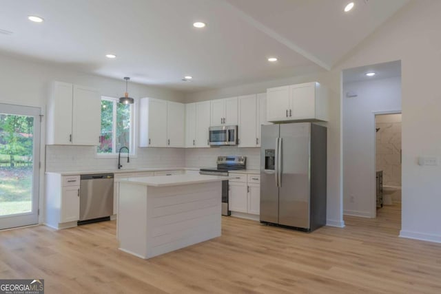 kitchen featuring light hardwood / wood-style flooring, stainless steel appliances, white cabinetry, and a healthy amount of sunlight