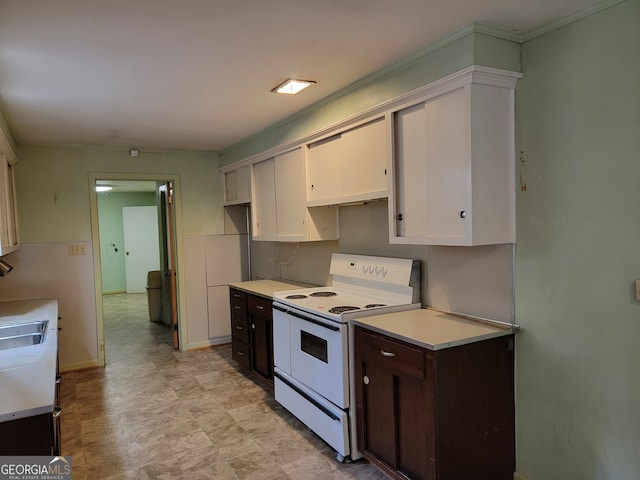 kitchen with dark brown cabinetry, white cabinetry, and white range with electric stovetop