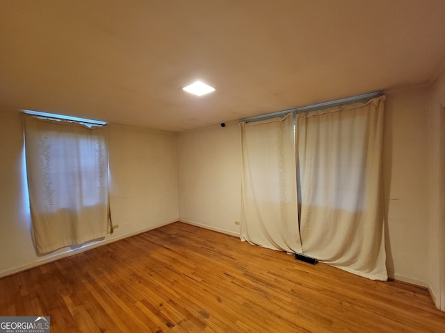 spare room with light hardwood / wood-style flooring