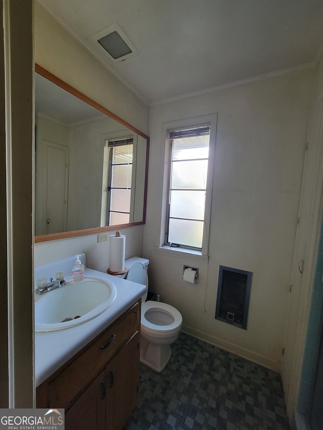 bathroom with ornamental molding, vanity, toilet, and heating unit