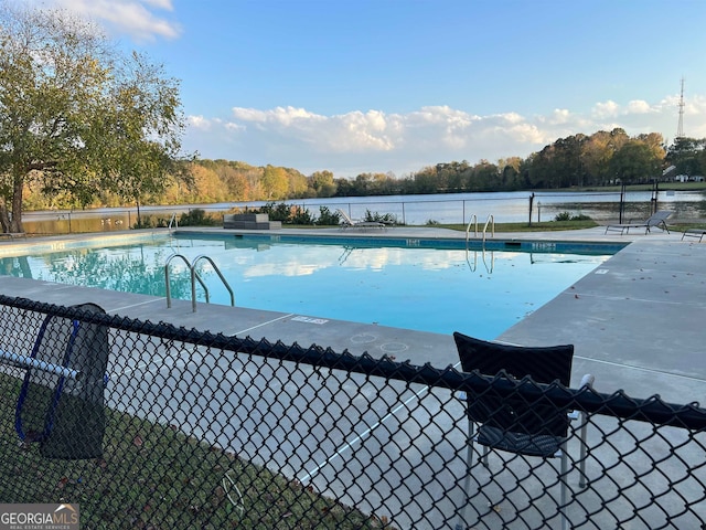 view of pool with a water view