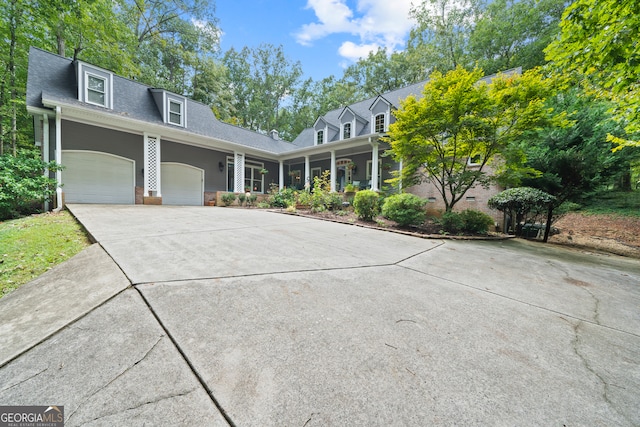 cape cod-style house featuring a garage