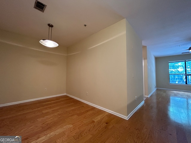 empty room featuring ceiling fan and hardwood / wood-style flooring