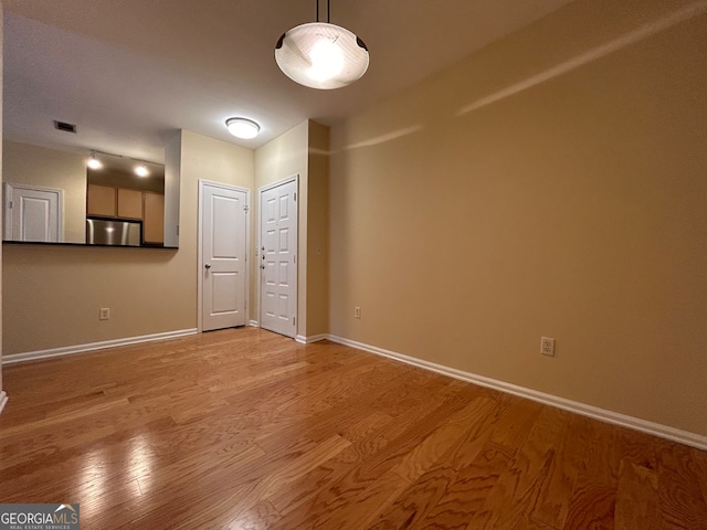 unfurnished living room with light hardwood / wood-style floors