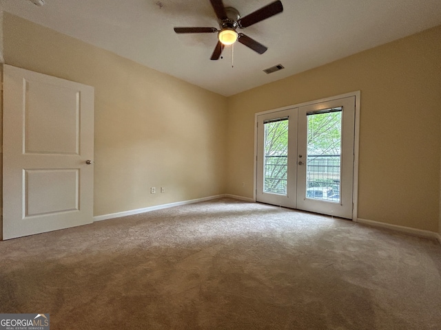 unfurnished room featuring carpet, ceiling fan, and french doors