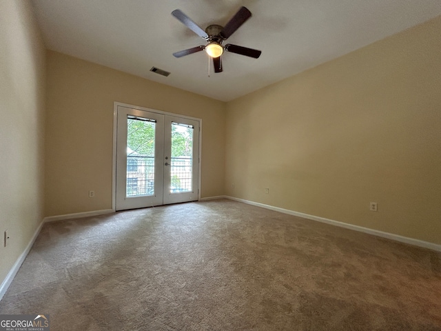 carpeted empty room with ceiling fan and french doors