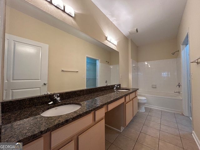 full bathroom featuring tiled shower / bath combo, tile patterned flooring, vanity, and toilet