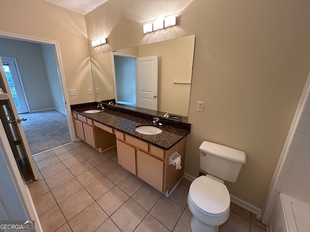 bathroom featuring tile patterned flooring, vanity, and toilet