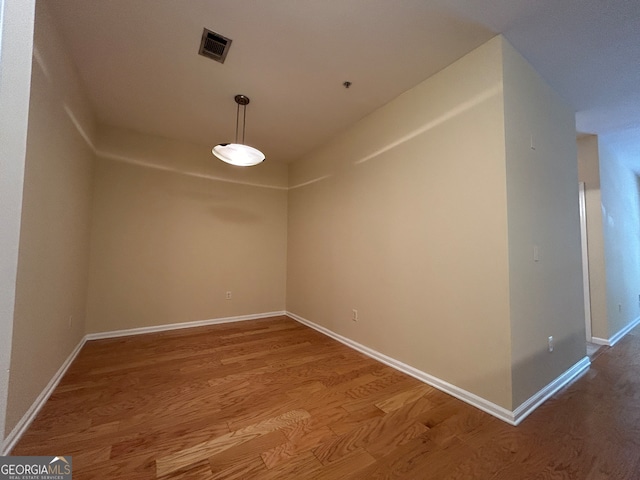 spare room with wood-type flooring