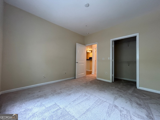 unfurnished bedroom with carpet floors and a closet