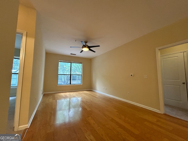 spare room featuring light hardwood / wood-style floors and ceiling fan