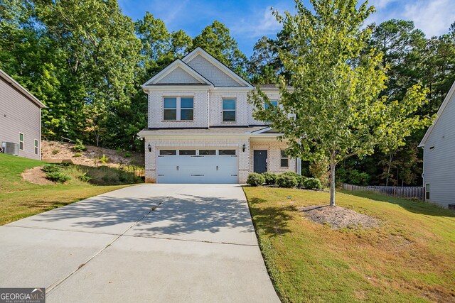 craftsman house featuring a front lawn and a garage