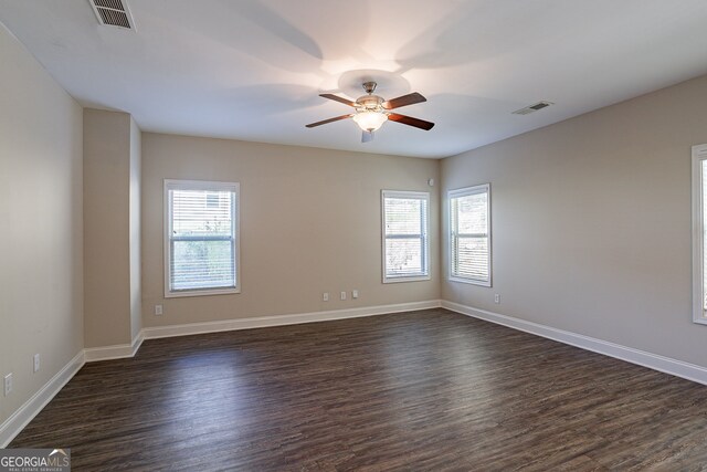 empty room featuring ceiling fan and dark hardwood / wood-style floors