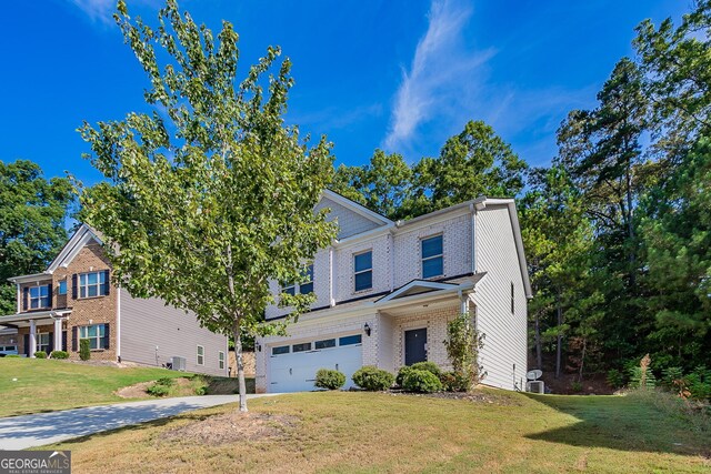 view of front of house featuring a front yard and a garage