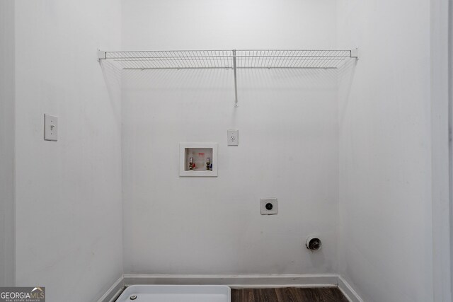 washroom with hookup for an electric dryer, hookup for a washing machine, and hardwood / wood-style floors