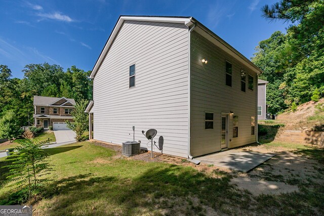 view of home's exterior featuring a lawn and a garage