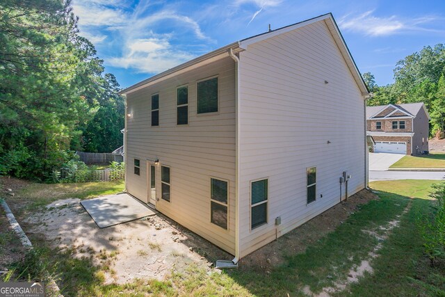 view of home's exterior with a patio and a garage