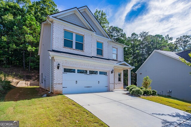 view of front of home with a front yard and a garage