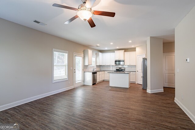 kitchen featuring white cabinetry, dark wood-type flooring, a kitchen island, stainless steel appliances, and ceiling fan