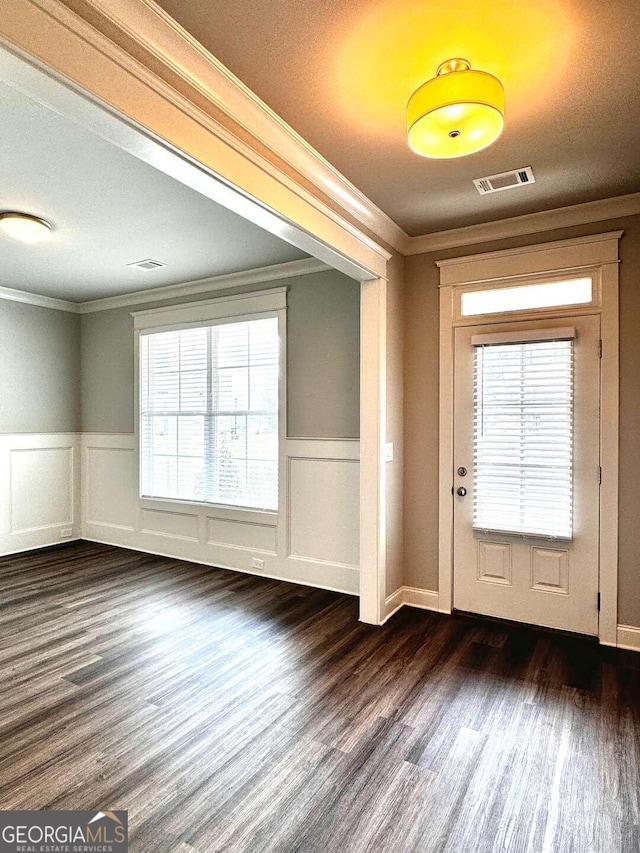 entryway featuring a textured ceiling, crown molding, and dark wood-type flooring