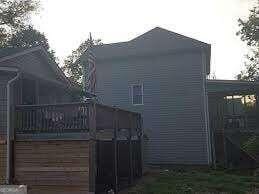 view of property exterior featuring a wooden deck