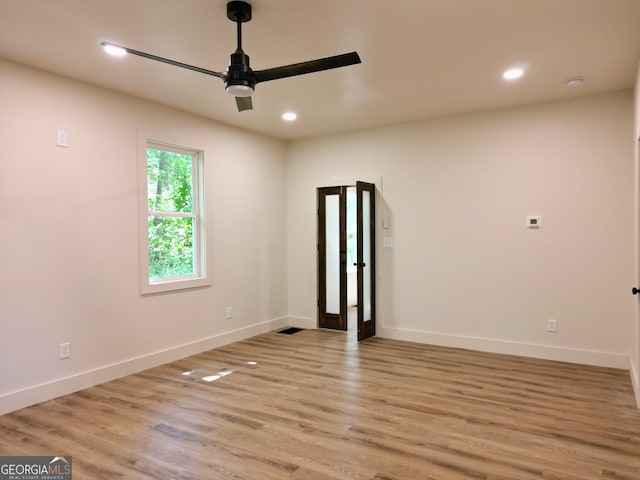 spare room featuring ceiling fan and light hardwood / wood-style flooring