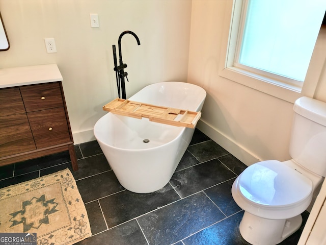 bathroom featuring tile patterned flooring, vanity, and toilet