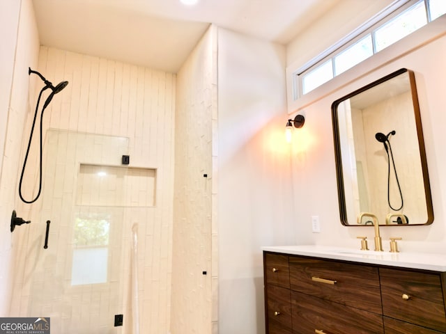 bathroom featuring vanity and an enclosed shower