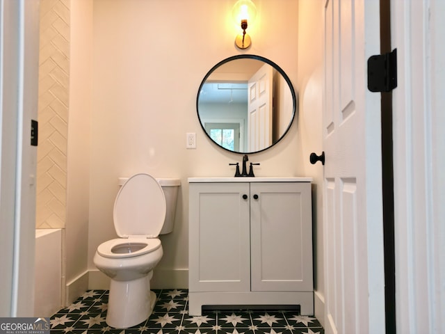 bathroom with tile patterned flooring, vanity, and toilet