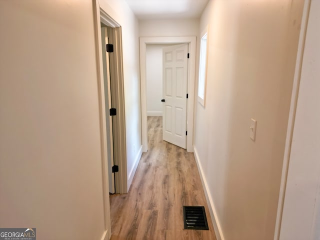 corridor with light wood-type flooring