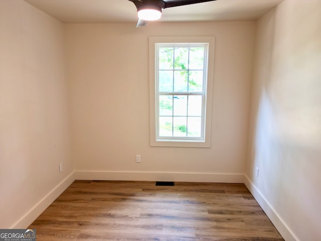 spare room with ceiling fan and hardwood / wood-style flooring