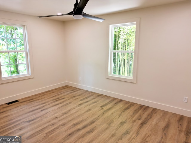 empty room with ceiling fan and light wood-type flooring