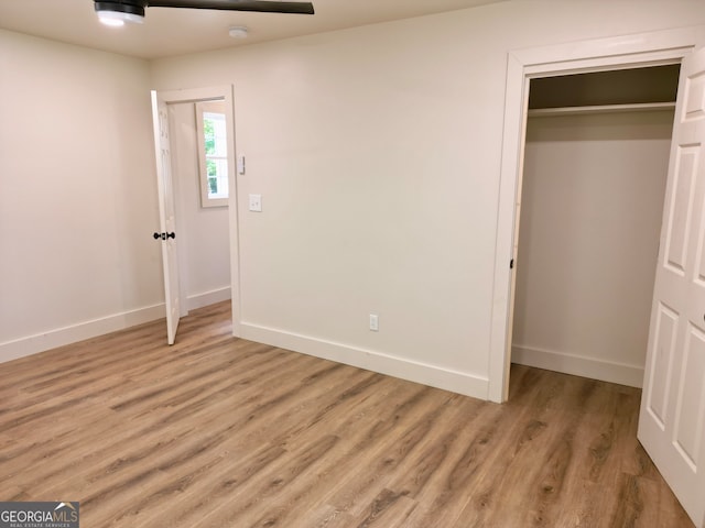 unfurnished bedroom featuring light hardwood / wood-style flooring and a closet