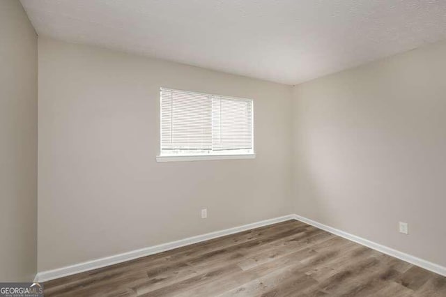 empty room with hardwood / wood-style floors