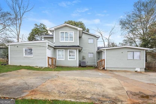 rear view of house featuring central AC