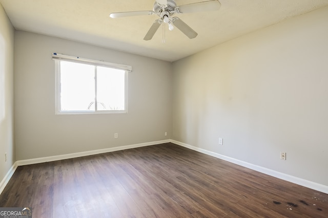 empty room with ceiling fan and dark hardwood / wood-style flooring