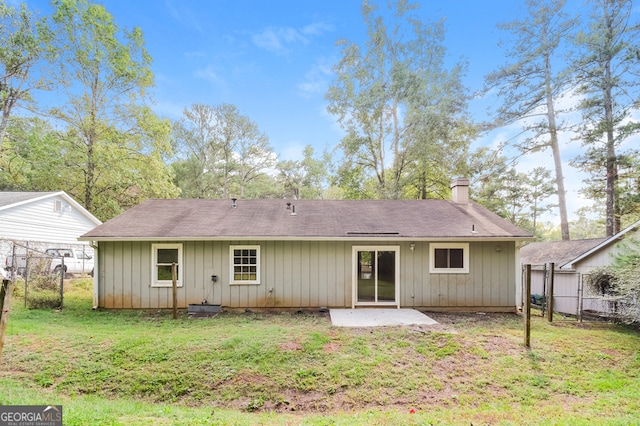 rear view of property featuring a patio area and a lawn