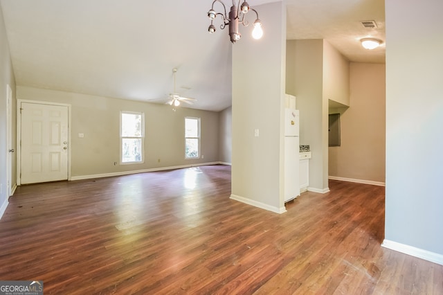 unfurnished living room featuring dark wood-type flooring and ceiling fan with notable chandelier