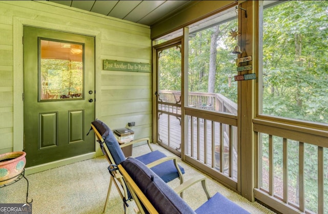 sunroom / solarium featuring wooden ceiling and a wealth of natural light