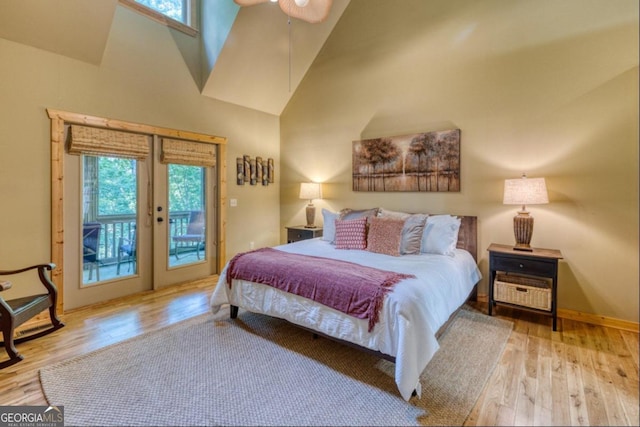 bedroom with light hardwood / wood-style flooring, high vaulted ceiling, access to exterior, and ceiling fan